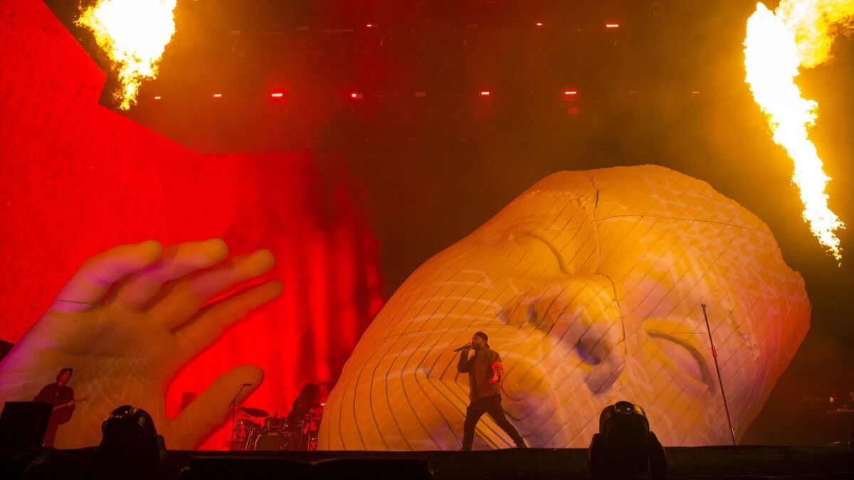 The Weeknd's stage set featured an image of an enormous mask.