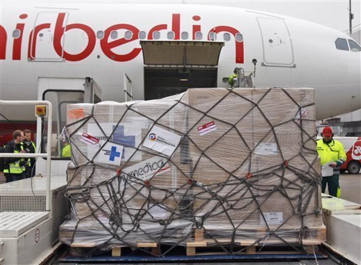 A load of aid stands ready to be loaded into a waiting plane, bound for the earthquake victims in Haiti, at the Duesseldorf Airport, western Germany, Monday Jan. 18, 2010. (AP Photo/Frank Augstein)
