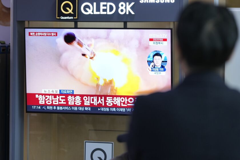 People watches a TV screen reporting North Korea's missile launch with file image during a news program at the Seoul Railway Station in Seoul, South Korea, Wednesday, March 22, 2023. North Korea launched multiple cruise missiles toward the sea on Wednesday, South Korea's military said, three days after the North carried out what it called a simulated nuclear attack on South Korea. The letters read "North, launched multiple cruise missiles." (AP Photo/Lee Jin-man)