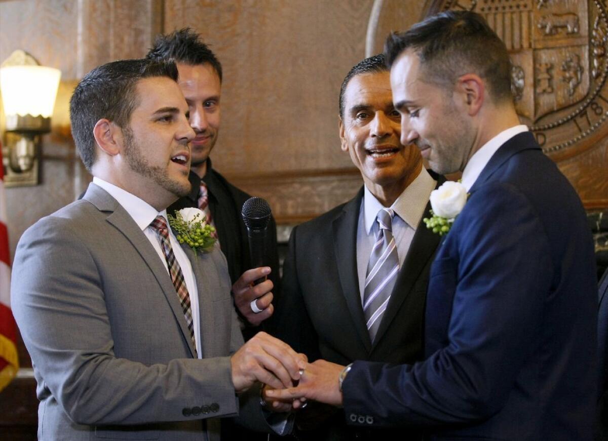 Burbank residents Jeff Zarillo and Paul Katami, right, during their wedding ceremony officiated by L.A. Mayor Antonio Villaraigosa, center, at City Hall in Los Angeles on June 28.