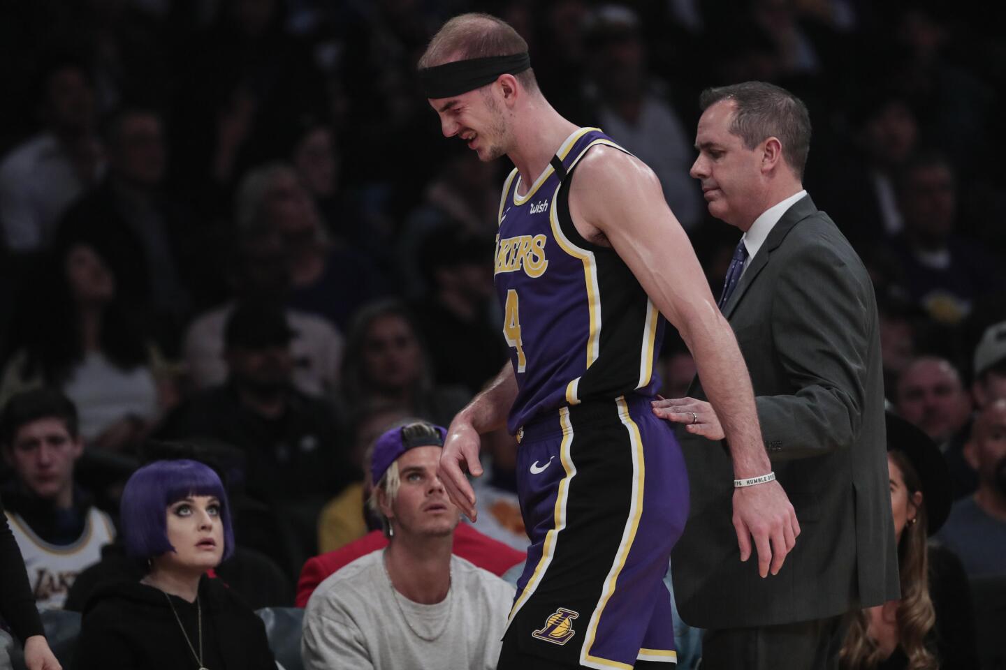 Lakers guard Alex Caruso exits after getting poked in the face.
