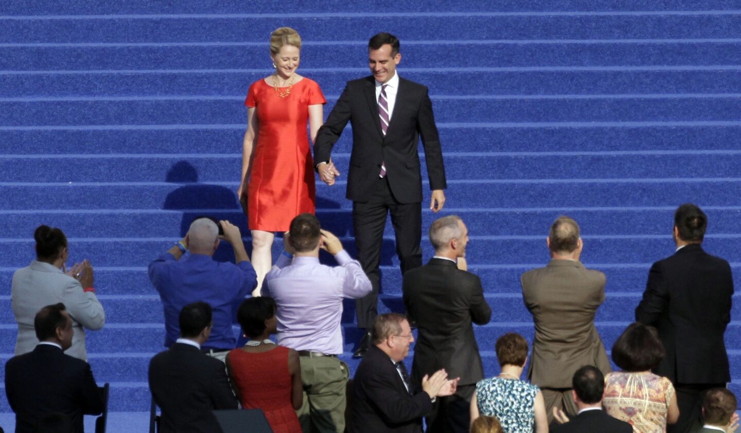 Eric Garcetti and his wife, Amy Wakeland, walk down the steps of City Hall moments before his swearing in.