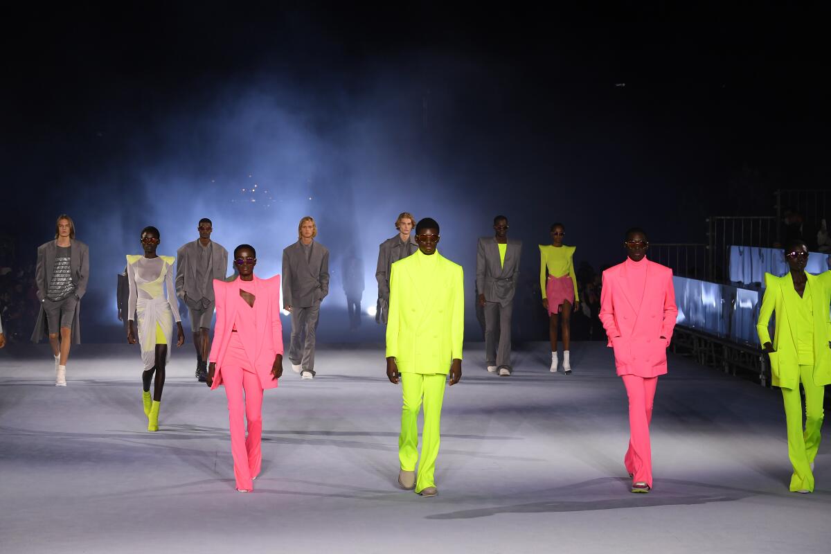 Models with pops of neon colors walking the runway at a Balmain fashion show