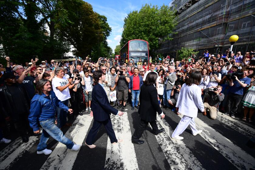 LONDON, ENGLAND - AUGUST 08: Beatles impersonators recreate the iconic 'Abbey Road' photograph made 50 years ago today, on August 8, 2019 in London, England. 50 years ago today, John Lennon, Paul McCartney, George Harrison and Ringo Starr held up traffic on the zebra crossing outside their recording studio in north London to get the cover shot for the album, Abbey Road. (Photo by Leon Neal/Getty Images) ** OUTS - ELSENT, FPG, CM - OUTS * NM, PH, VA if sourced by CT, LA or MoD **