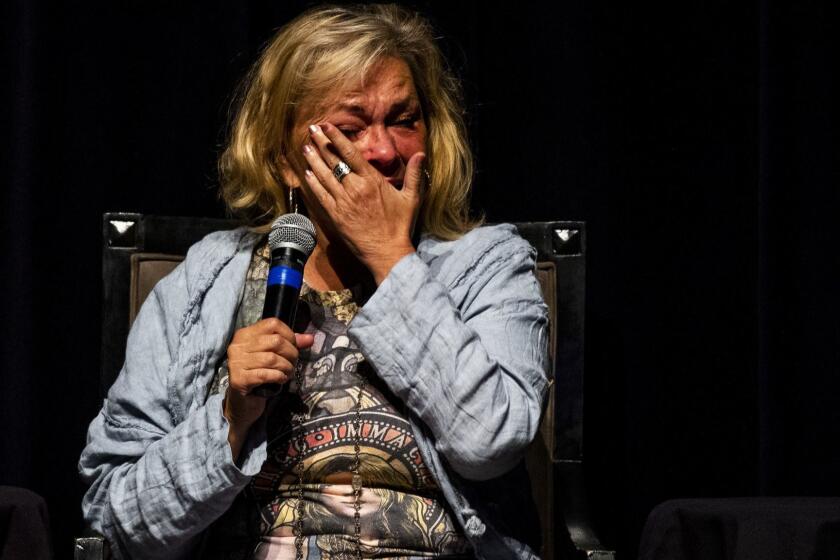 BEVERLY HILLS, CALIF. - SEPTEMBER 17: Comedian Rosanne Barr wipes away tears while speaking with Rabbi Shmuley Boteach and Editor of The Jewish Journal, David Suissa all of whom were participating in a discussion on atonement and repentance on the eve of Yom Kippur at the Saban Theater on Monday, Sept. 17, 2018 in Beverly Hills, Calif. This is Barr's first public appearance since being fired from her series "Rosanne" after sending out a racially offensive tweet. (Kent Nishimura / Los Angeles Times)