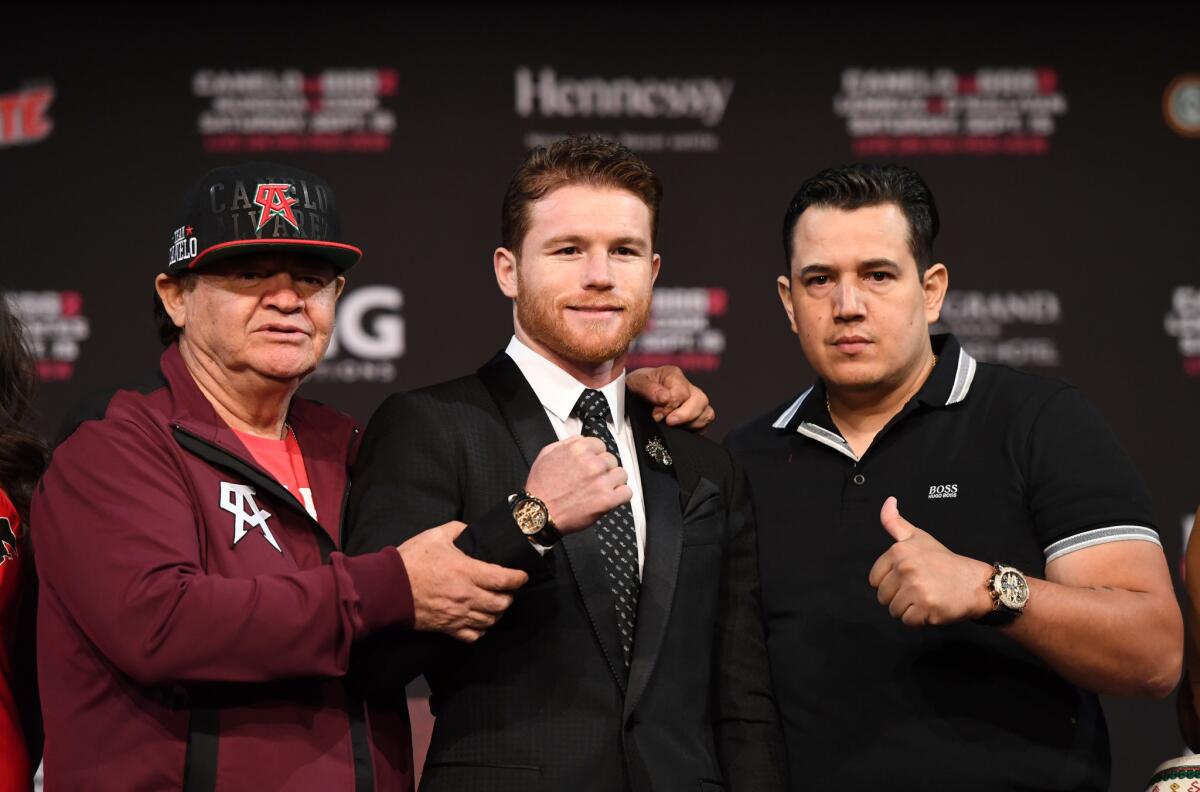 Boxer Canelo Alvarez (C), his manager/trainer Jose "Chepo" Reynoso (L) and trainer Eddy Reynoso (R) pose after a news conference at MGM Grand Hotel & Casino on September 12, 2018 in Las Vegas, Nevada. Alvarez will challenge WBC/WBA middleweight champion Gennady Golovkin for his titles in a rematch on September 15 at T-Mobile Arena in Las Vegas.