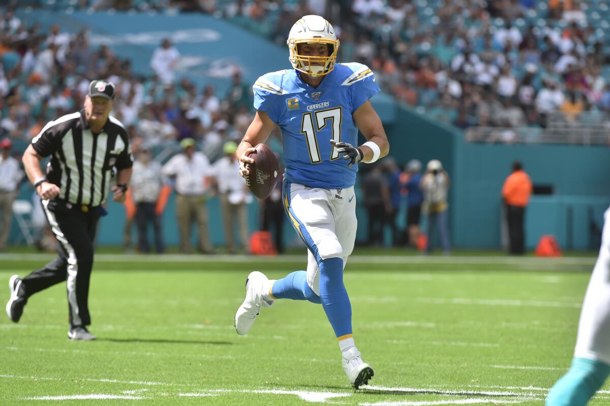 Chargers' Philip Rivers passes on the run. 