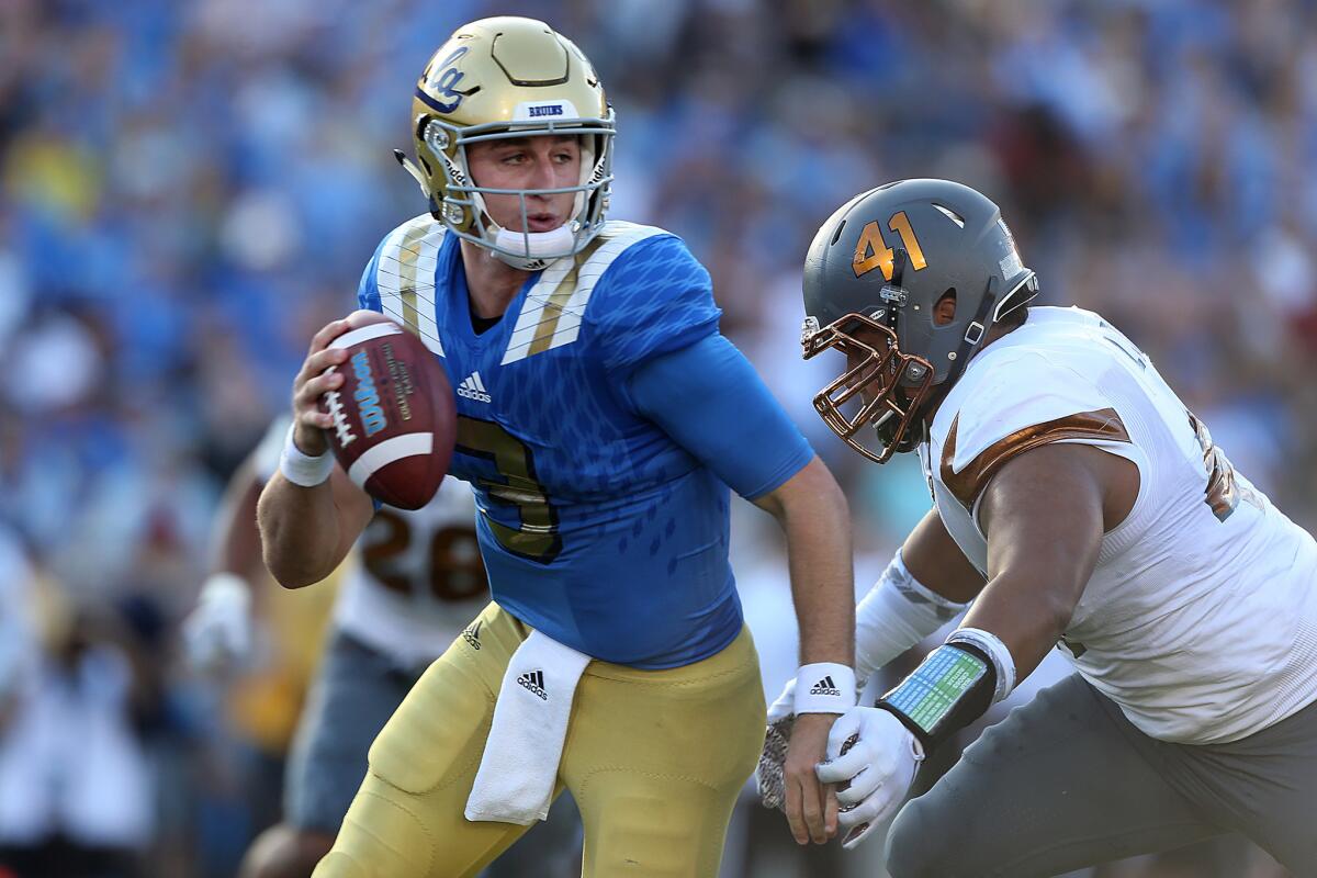 UCLA quarterback Josh Rosen is sacked for a safety by ASU defensive lineman Viliami Latu during first quarter action at the Rose Bowl.