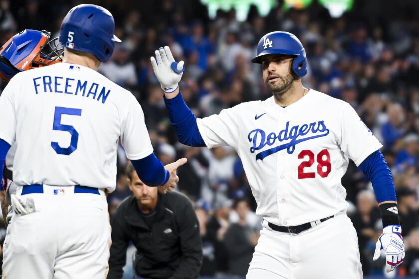 Los Angeles, CA - April 18: Los Angeles Dodgers' J.D. Martinez, right, celebrates with first baseman Freddie Freeman at home plate after a two-run home run against the New York Mets during the first inning at Dodger Stadium on Tuesday, April 18, 2023 in Los Angeles, CA.(Wally Skalij / Los Angeles Times)