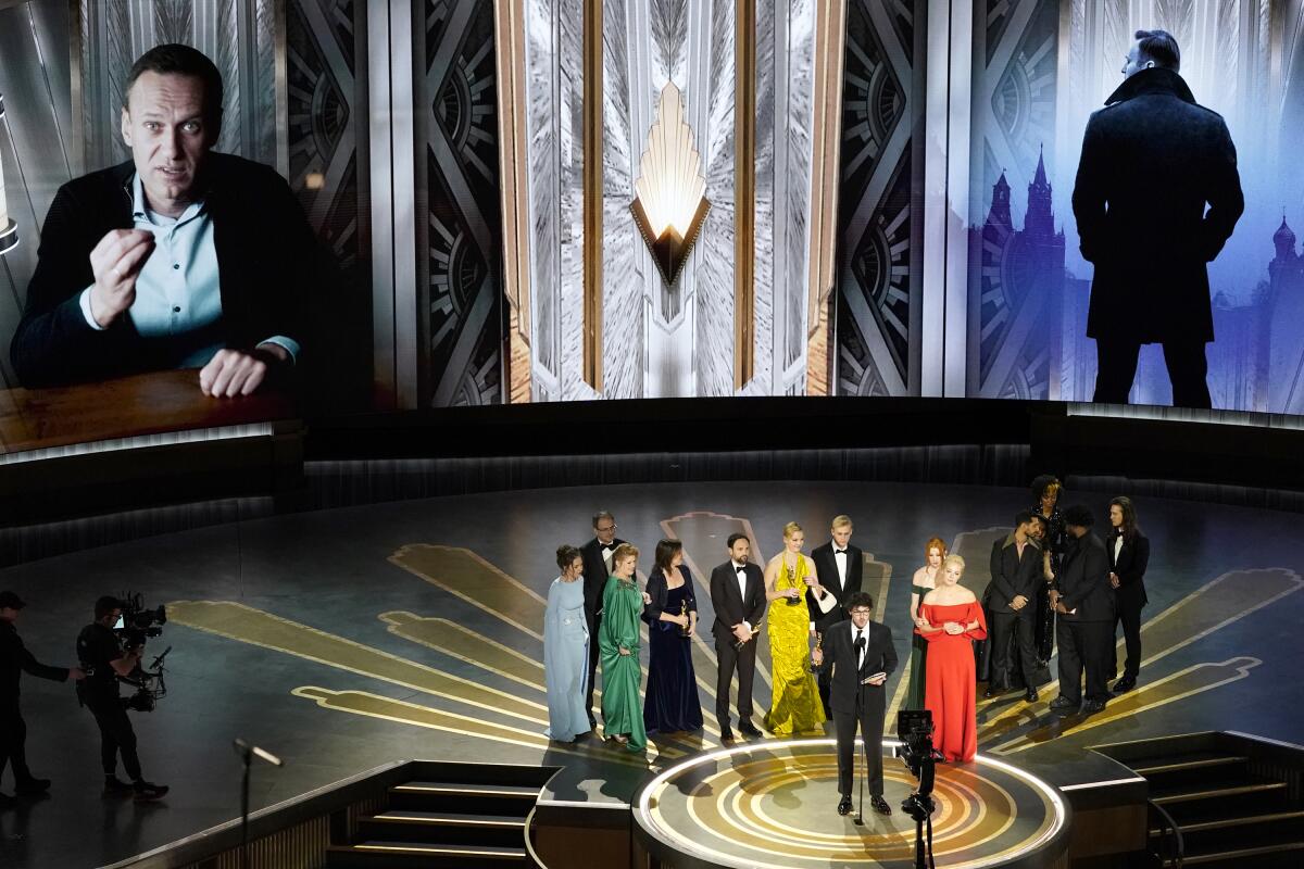 Daniel Roher and the members of the crew from 'Navalny' accept their Oscar.