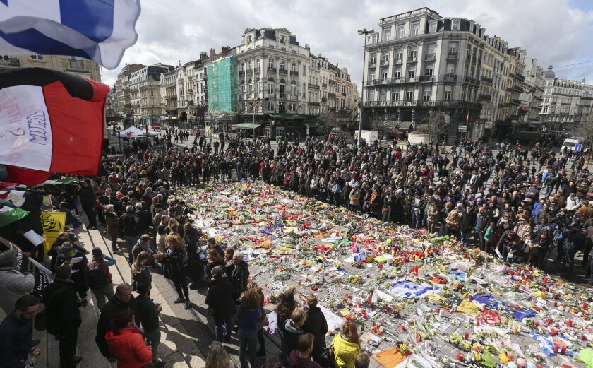 People gather to commemorate the victims of the March 22 terror attacks at the site of a memorial in Brussels, Belgium, on March 27.