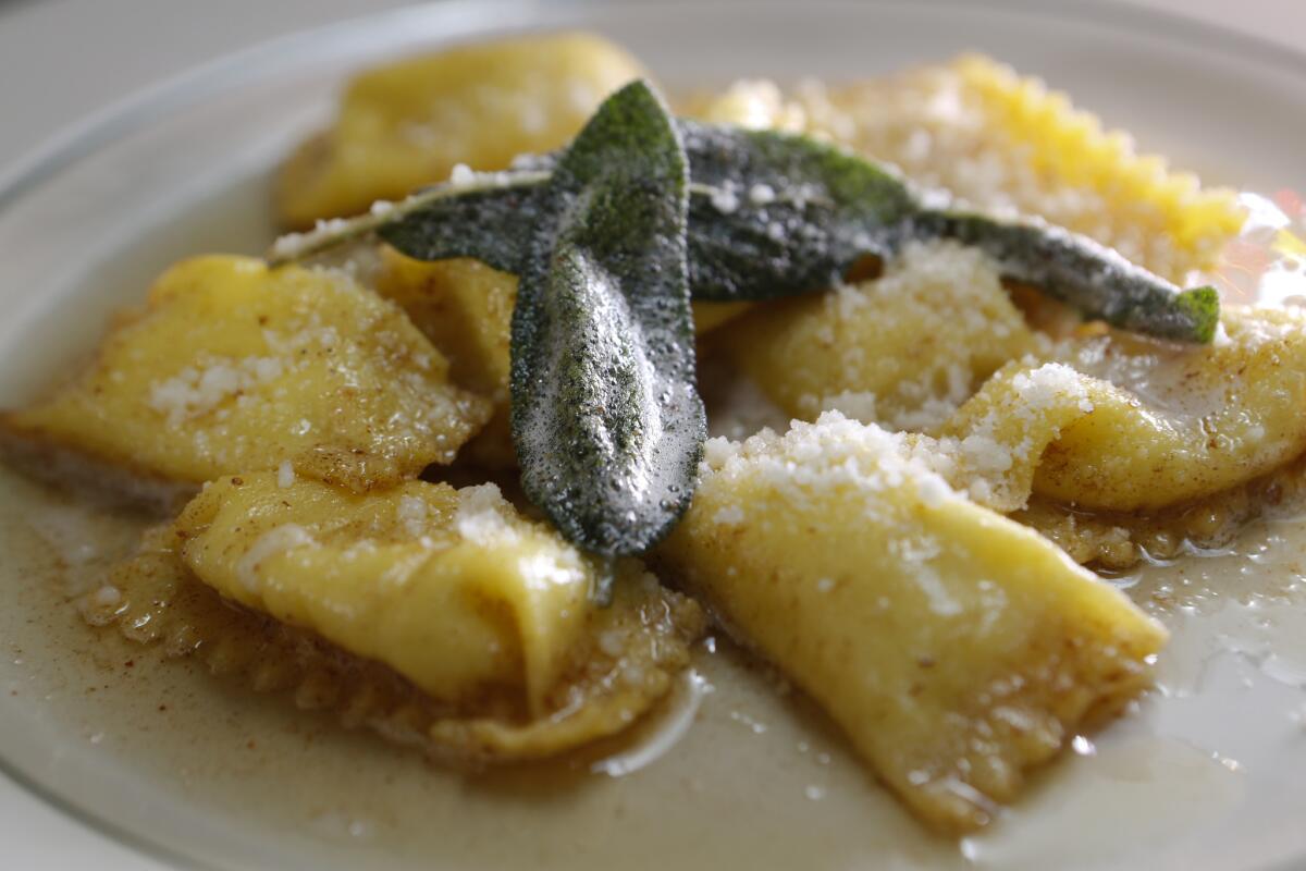Corn agnolotti topped with sage brown butter and Parmesan.