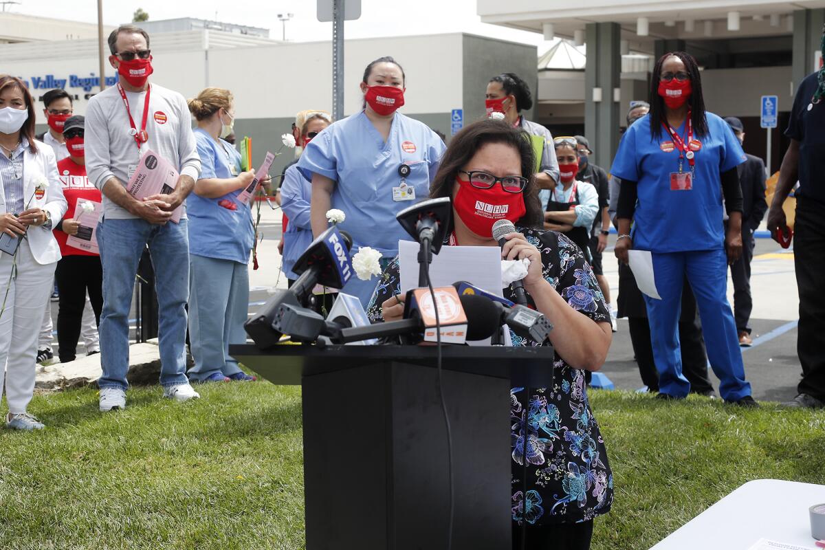 Respiratory therapist Christina Rodriguez speaks at a press conference outside Fountain Valley Regional Hospital.