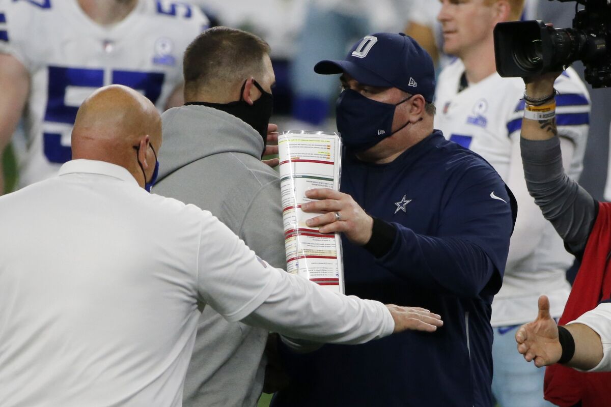 New York Giants head coach Joe Judge, center left, and Dallas Cowboys head coach Mike McCarthy, center right, greet each other after their NFL football game in Arlington, Texas, Sunday, Oct. 11, 2020. (AP Photo/Michael Ainsworth)