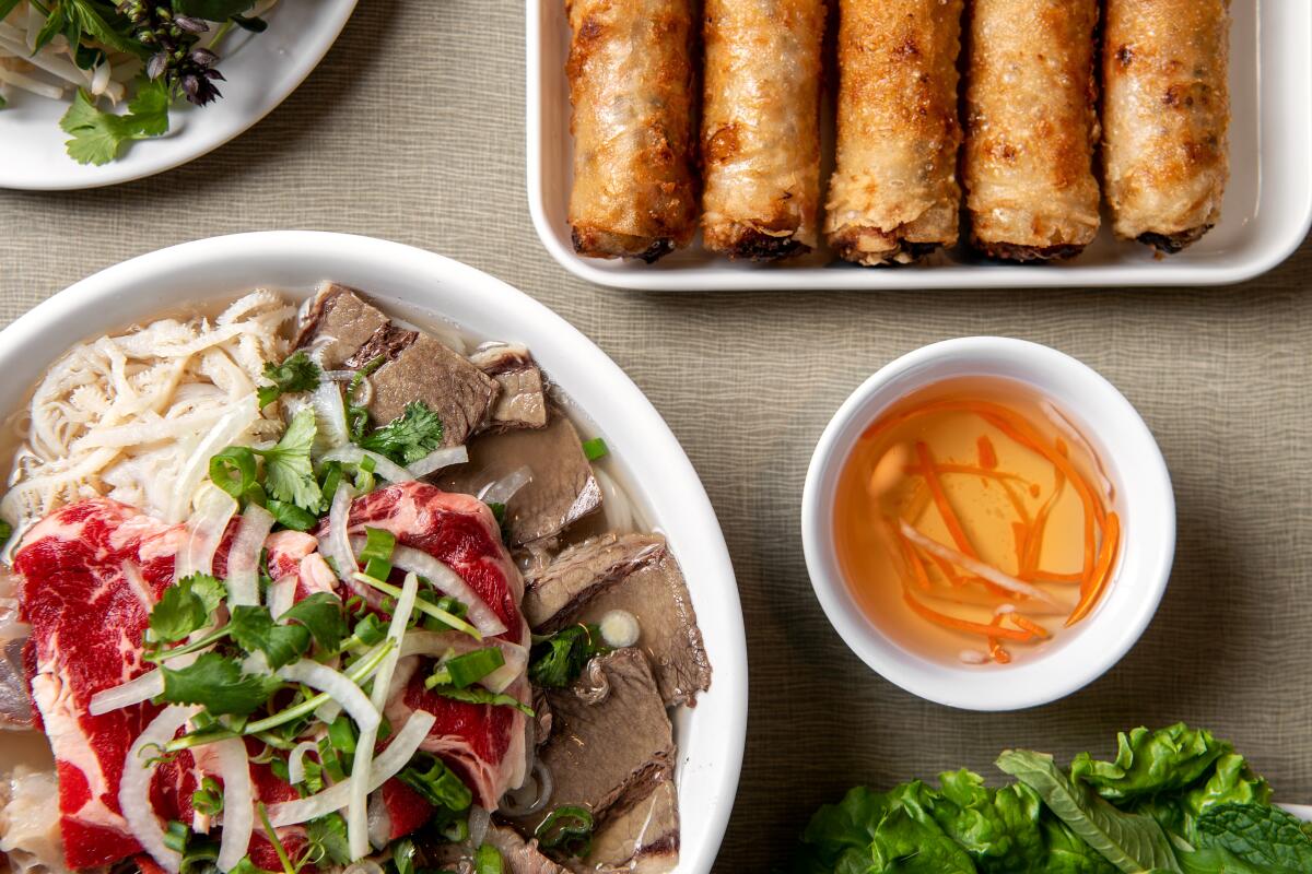 SAN GABRIEL, CA - NOVEMBER 10:Pho dac biet (Tai, Nam, Gan, Sach)-rib eye, brisket, tendon & tripe rice noodle soup and phan cha gio -fried pork egg rolls served w/vegetables from Golden Deli on Friday, Nov. 10, 2023 in San Gabriel, CA. (Mariah Tauger / Los Angeles Times)