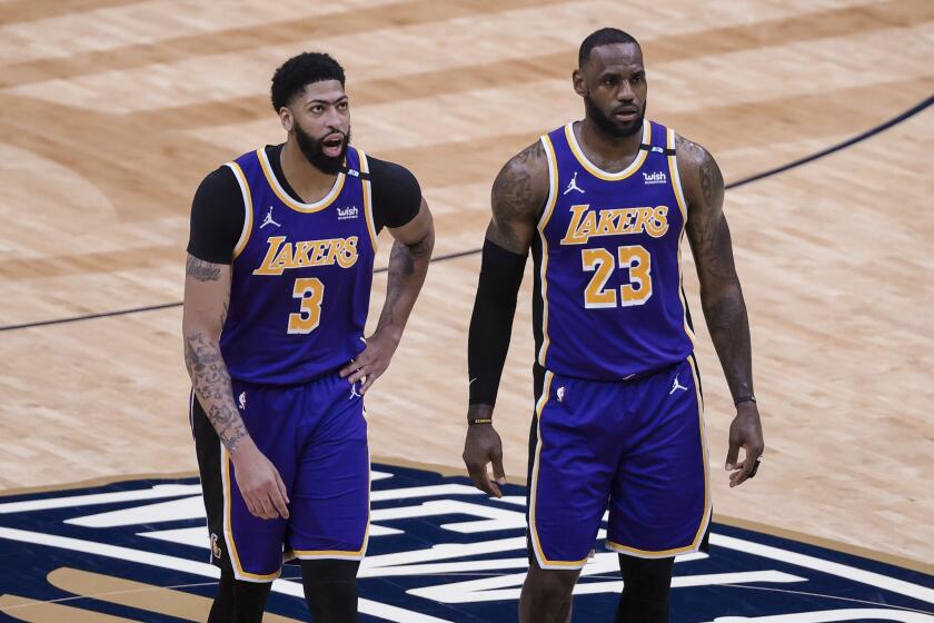 Los Angeles Lakers forward LeBron James (23) and forward Anthony Davis (3) during a time out in the second quarter of an NBA basketball game against the New Orleans Pelicans in New Orleans, Sunday, May 16, 2021. (AP Photo/Derick Hingle)