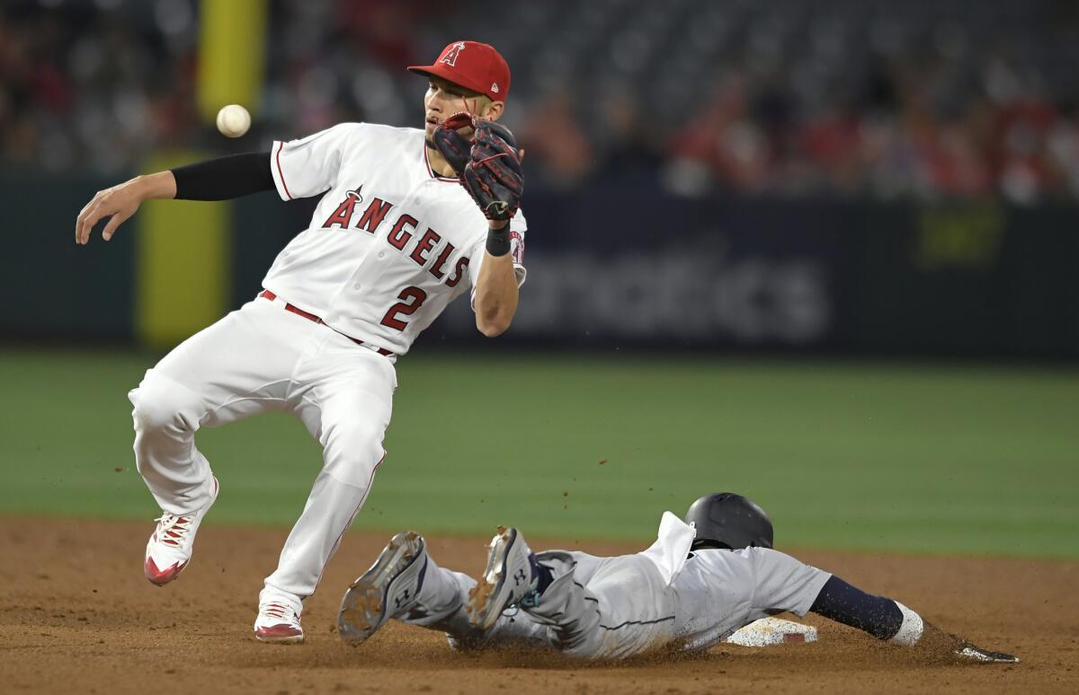 Seattle Mariners' Dee Gordon steals second base while Angels' Andrelton Simmons gets the throw late in the sixth inning at Angel Stadium on Thursday.