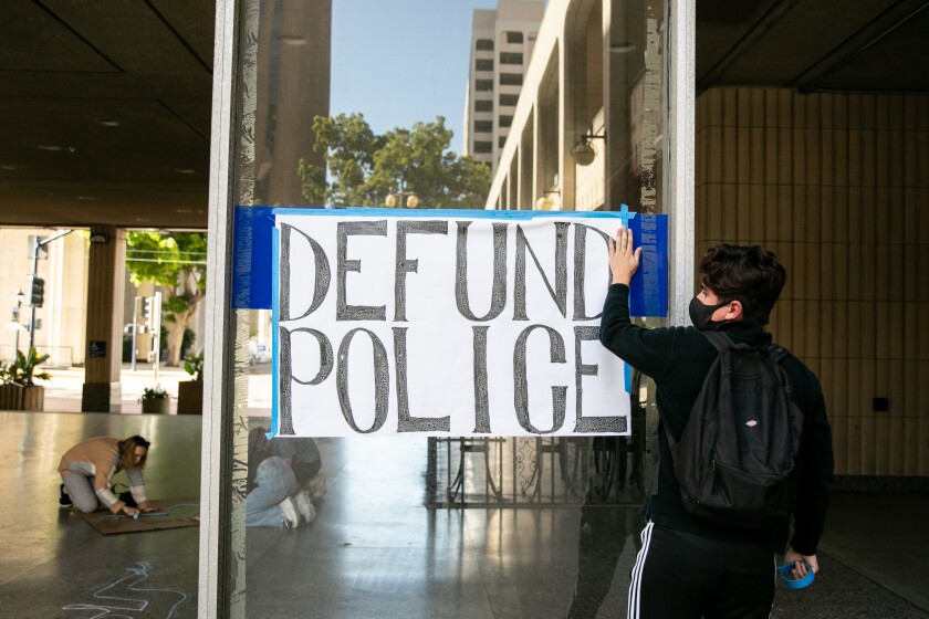 Protesters outside San Diego City Hall on June 8 asked that some police funding be diverted to a rental assistance program.