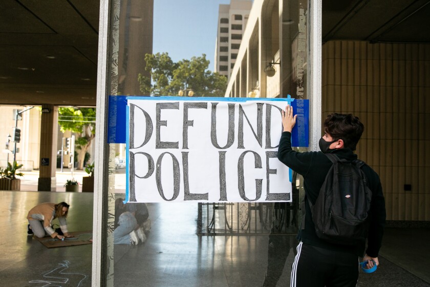 Protesters outside San Diego City Hall urged the council to reduce police funding