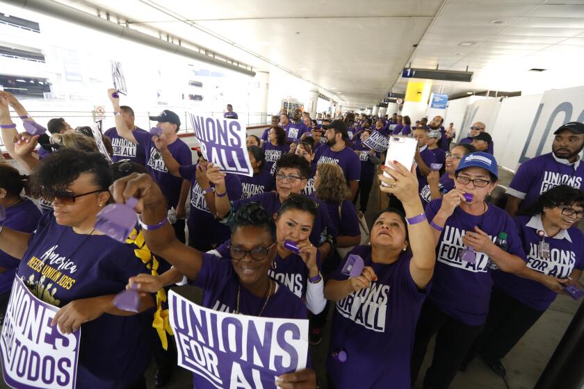 LOS ANGELES, CA - OCTOBER 2, 2019 - - Hundreds of airport workers, Uber and Lyft drivers, janitors, LA City workers, LA County workers, fast-food workers, home care providers and child care providers with other union march through Terminal One at the Los Angeles International Airport in Los Angeles on October 2, 2019. The marchers are demanding that elected officials, locally, statewide and federally, take action to support unions for all people--no matter where they work. Workers also marched for better pay and benefits and want to unionize. The rally is on behalf of all kinds of workers, from rideshare to fast food to airport service workers. Speakers included California Democratic Sen. Kamala Harris, Los Angeles County Supervisor Janice Hahn, Rev. Jesse Jackson, former state Sen. Kevin de Leon and Mary Kay Henry, president of the Service Employees International Union. The Rev. Jesse Jackson was also in attendance. (Genaro Molina / Los Angeles Times)