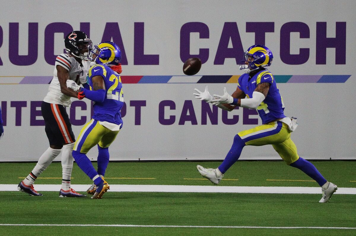 Rams' Troy Hill tips a pass meant for Bears receiver Darnell Mooney as safety Taylor Rapp comes in to make the interception.