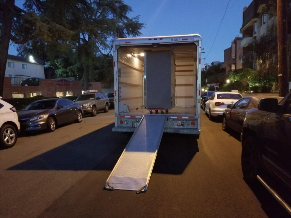 A refrigerator inside the back of a truck 