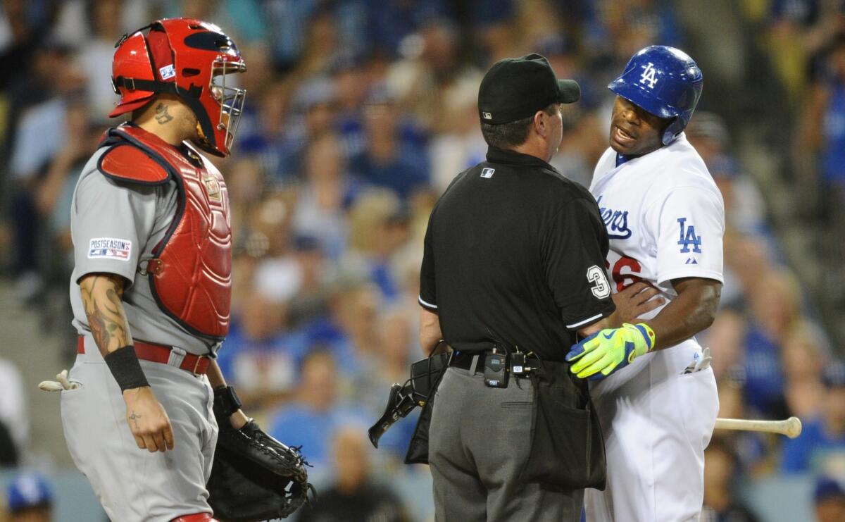 Dodgers center fielder Yasiel Puig has a few words for Cardinals catcher Yadier Molina after striking out in the second inning after he was nearly hit with a pitch.