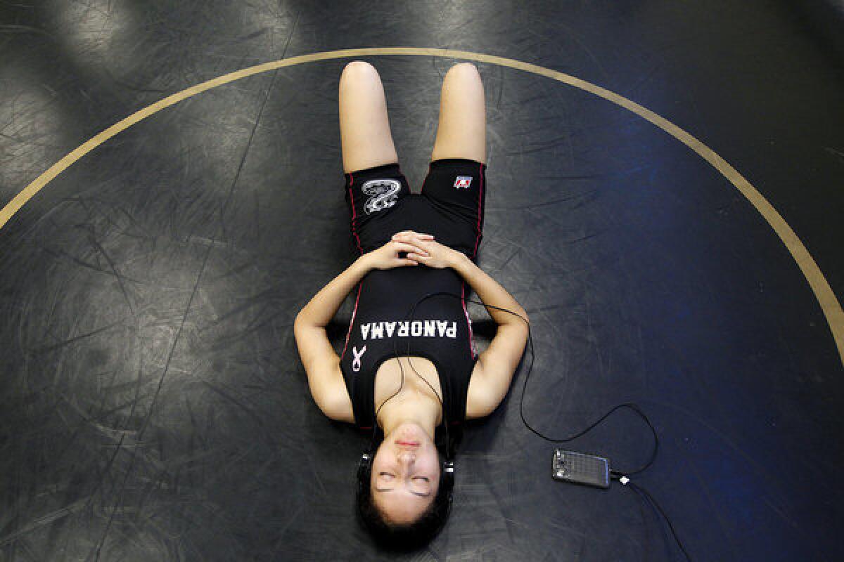 Panorama High wrestler Diana Oliva listens to boy band One Direction before a home match.