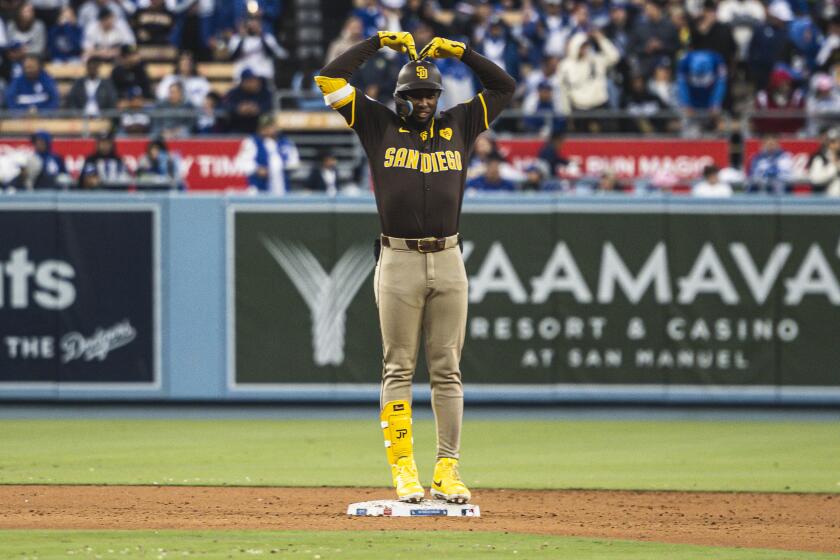 LOS ANGELES, CALIFORNIA - APRIL 14: Jurickson Profar #10 of the San Diego Padres celebrates after hitting a 3-run double in the seventh inning against the Los Angeles Dodgers at Dodger Stadium on April 14, 2024 in Los Angeles, California.(Photo by Matt Thomas/San Diego Padres/Getty Images)