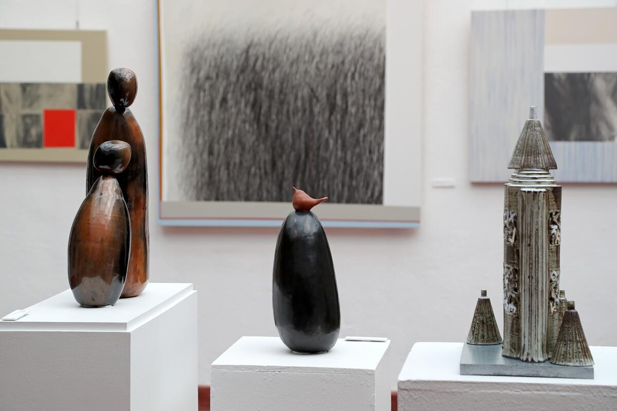 Sculptures by artists Marsha Judd, at left and center, and Young Shin Kim on display during the "Embrace" exhibition. 