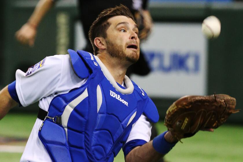 Dodgers catcher Drew Butera makes a catch during an exhibition game featuring MLB players in Tokyo on Nov. 16.
