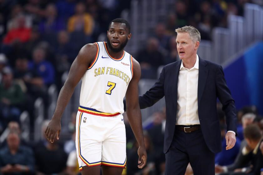 Warriors coach Steve Kerr talks to rookie forward Eric Paschall during a break in play against the Trail Blazers on Nov. 4, 2019, in San Francisco.