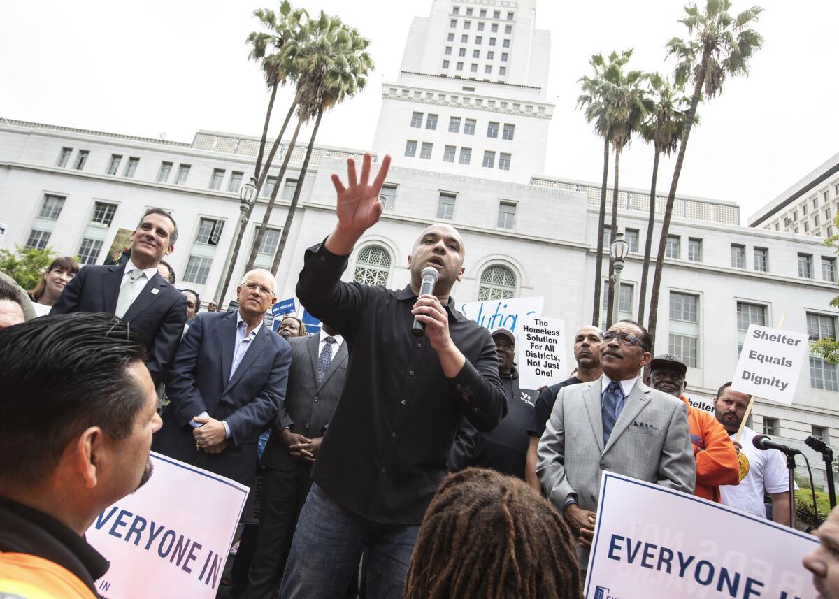 Homeless advocate Mel Tillekeratne speaks in support of temporary housing for the homeless in Los Angeles.