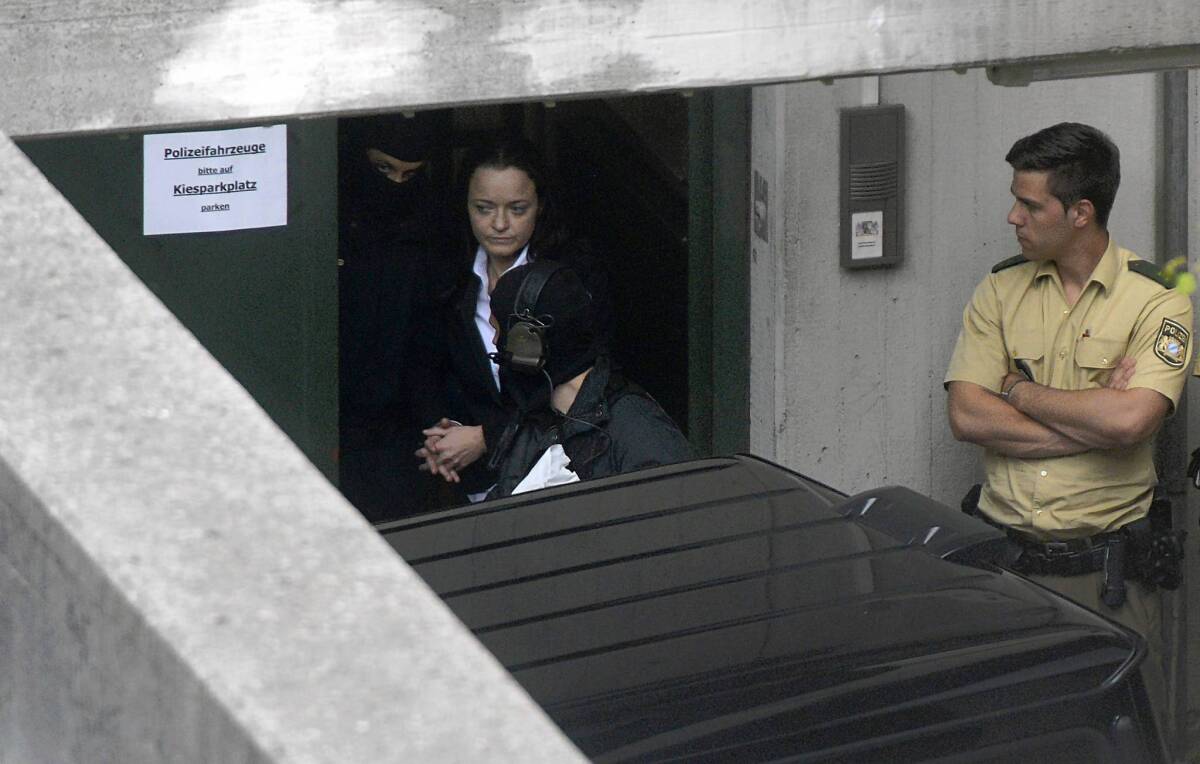 Beate Zschaepe is escorted out of the courthouse in Munich, Germany, after the first day of her trial.