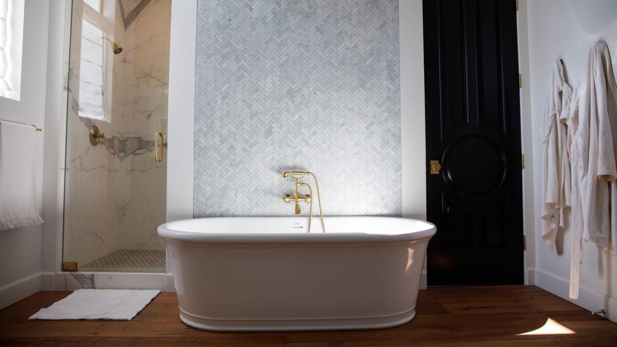 LOS ANGELES, CA--MAY 12, 2017--In the master bathroom, Carrara marble on the wall and shower contrast with rustic wide plank oak floors, of Jamie Klasfeld's Studio City, CA., home, photographed May 12, 2017. (Jay L. Clendenin / Los Angeles Times)