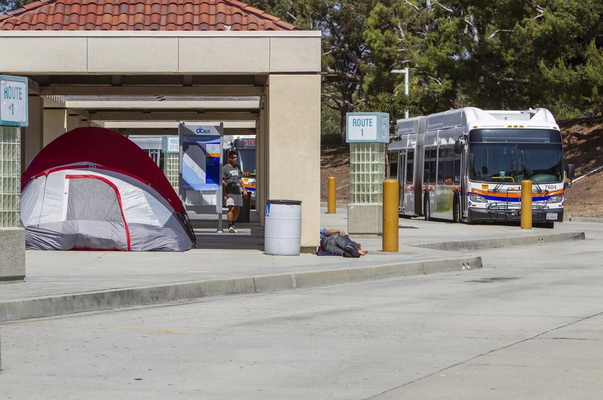 Tents inhabited by homeless people occupy parts of the Newport Beach transit center on Avocado Avenue on Sept. 10. The encampment was removed late Wednesday.