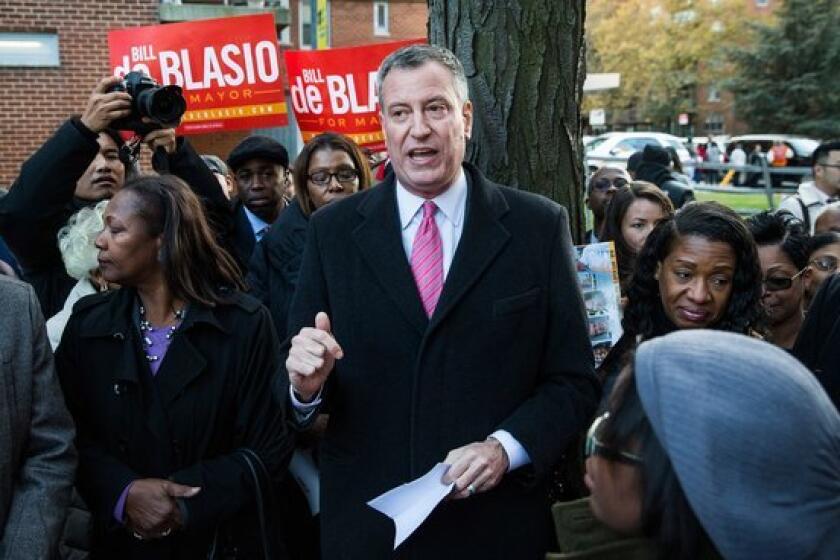 New York City Mayoral candidate Bill De Blasio speaks to campaign supporters in a public housing village in the Queens borough of New York City.