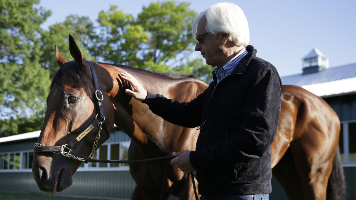 Trainer Bob Baffert stands next to Triple Crown winner American Pharoah at Belmont Park in Elmont, N.Y., on June 7, 2015, the day after the colt won the Belmont Stakes.