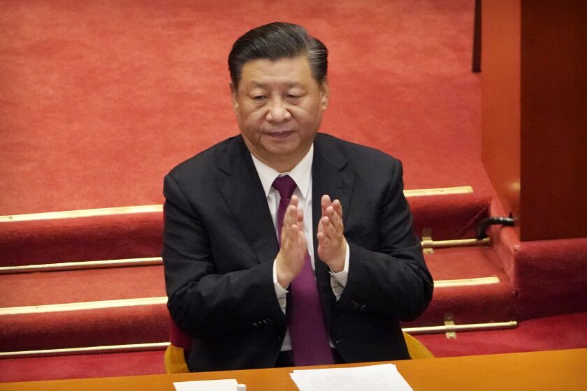 FILE - Chinese President Xi Jinping applauds during the closing session of the Chinese People's Political Consultative Conference (CPPCC) at the Great Hall of the People in Beijing, Wednesday, March 10, 2021. Xi is expected talk to global leaders at the U.N. climate summit in Glasgow, Scotland, by video link, the foreign ministry announced Friday, Oct. 29, 2021. (AP Photo/Mark Schiefelbein, File)