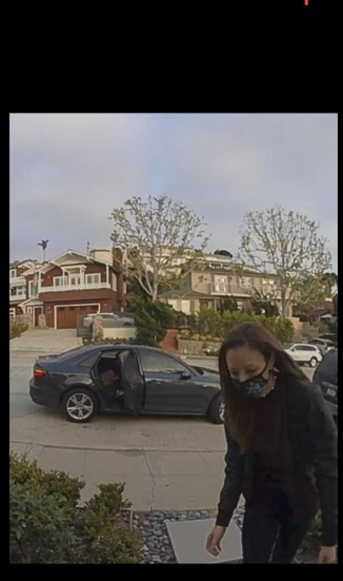 Home security footage shows a woman suspected of stealing packages from La Jolla porches and loading them in a waiting car.
