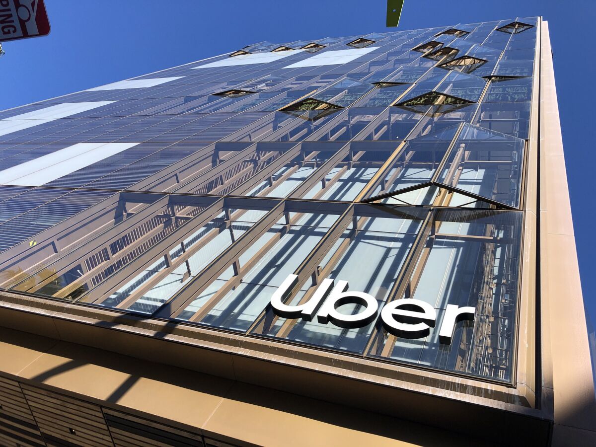 A view looking up at Uber's facade shows accordion windows that are partially open.