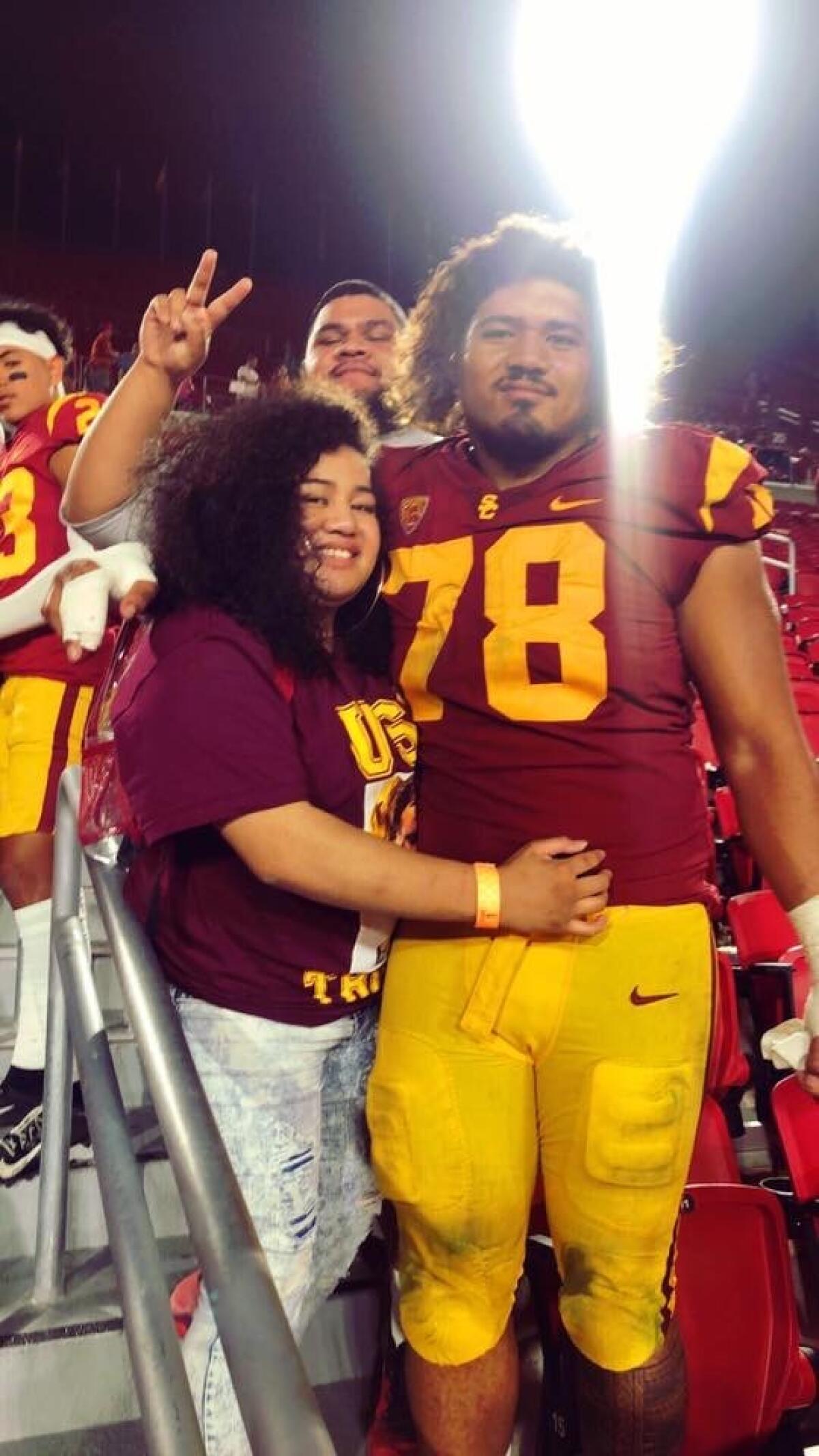 USC defensive lineman Jay Tufele is shown with his sister Noreen after a game at the Coliseum.