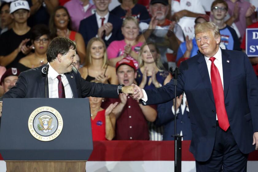 President Donald Trump, right, shakes hands with 12th Congressional District Republican candidate Troy Balderson, left, during a rally, Saturday, Aug. 4, 2018, in Lewis Center, Ohio. (AP Photo/John Minchillo)