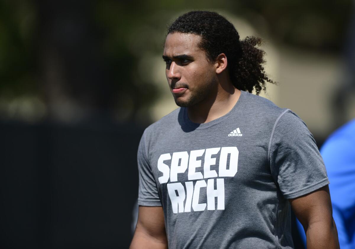 UCLA linebacker Eric Kendricks walks to an interview during UCLA's pro day Tuesday, where players worked out for scouts on the Bruins' practice field.