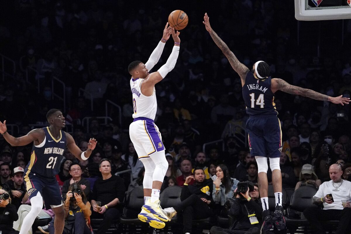 Lakers guard Russell Westbrook shoots as New Orleans Pelicans forwards Brandon Ingram and Tony Snell defend