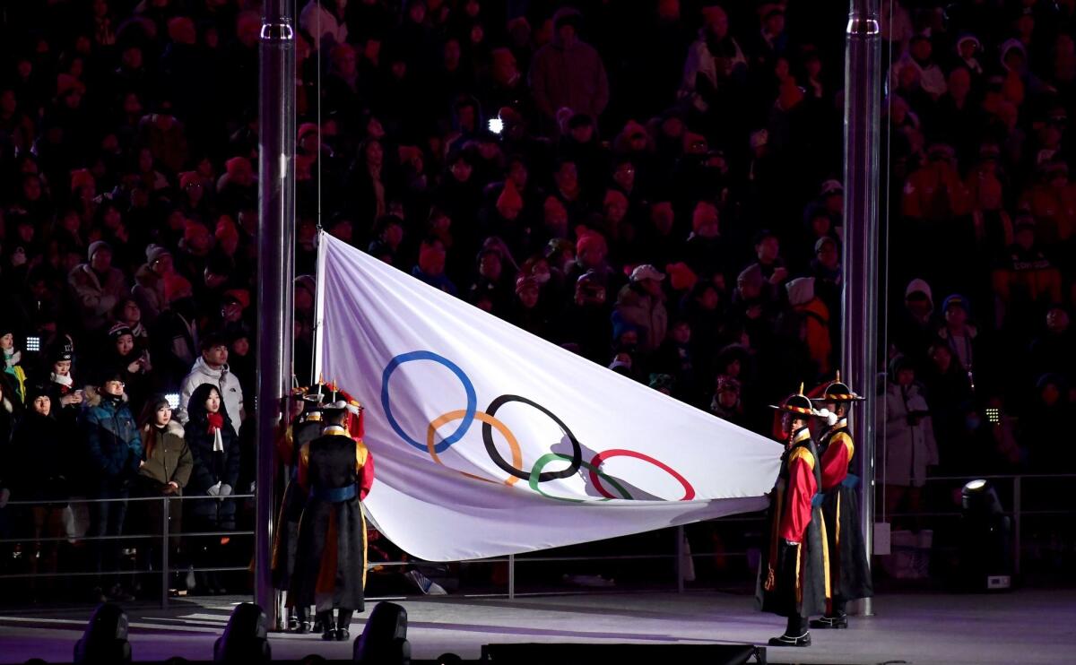 The Olympic flag is lowered during the closing ceremony of the 2018 Pyeongchang Olympics.