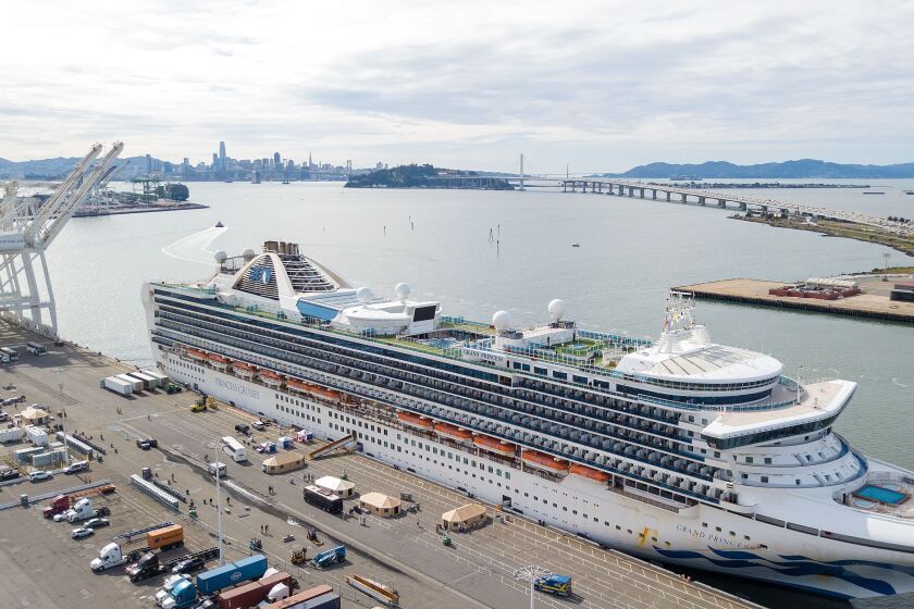 Tents begin to appear as workers tend to passengers disembarking from the Grand Princess cruise ship at the Port of Oakland in California on March 09, 2020.