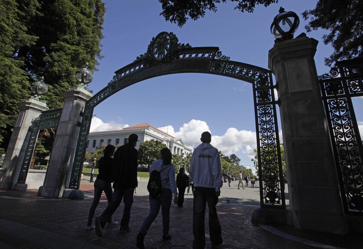 A group of students walk through Sather Gate on the UC Berkeley campus.