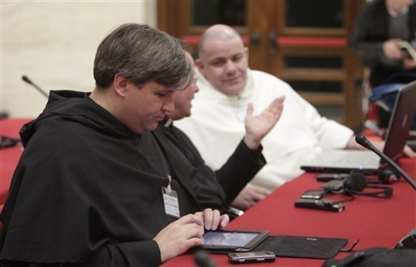 Brother Miguel de la Lastra Montalban uses his iPad to connect to the Internet during a meeting of Catholic bloggers at the Vatican, Monday, May 2, 2011. The Vatican has invited 150 Catholic bloggers to attend a first-ever blogging summit Monday, increasingly aware of the role that faith-based blogging is playing in spreading Catholicism. (AP Photo/Pier Paolo Cito)