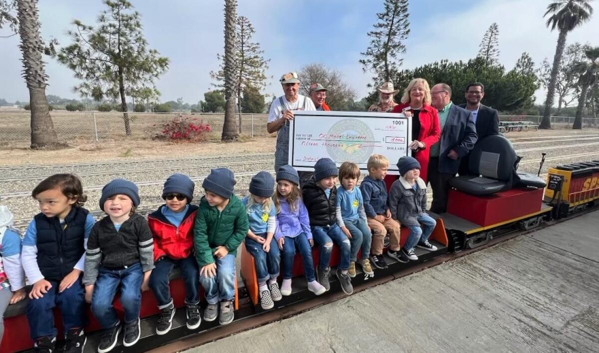 County Supervisor Katrina Foley presents a check to the O.C. Model Engineers at Fairview Park.